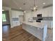 Bright kitchen featuring an island with quartz countertops, modern cabinets, and stainless steel appliances at 104 Gin Branch Rd, Wendell, NC 27591