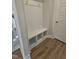 Mudroom features a built-in bench with cubbies and coat hooks, complemented by wood-look flooring at 104 Gin Branch Rd, Wendell, NC 27591