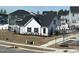 Charming white cottage-style home with black shutters, fenced yard, and a well-manicured lawn at 137 Shadowdale Ln, Rolesville, NC 27571