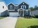 Charming two-story home with a well-manicured lawn and a driveway leading to a one-car garage at 137 Shadowdale Ln, Rolesville, NC 27571