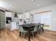 Bright open-concept kitchen and dining area with modern white cabinetry and stainless steel appliances at 137 Shadowdale Ln, Rolesville, NC 27571
