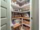 Well-organized walk-in pantry with shelving, baskets and wood countertop at 137 Shadowdale Ln, Rolesville, NC 27571