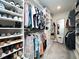 Walk-in closet with custom shelving and hanging racks for optimal storage and organization at 137 Shadowdale Ln, Rolesville, NC 27571