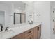 Double vanity bathroom with modern fixtures and a large mirror at 1429 Patchings Ln, Knightdale, NC 27545