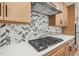 Modern kitchen features gas cooktop and herringbone backsplash at 1429 Patchings Ln, Knightdale, NC 27545