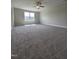Expansive bonus room with large windows, neutral carpet and natural light at 7420 Prato Ct, Wendell, NC 27591