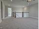 A large bonus room with neutral walls and carpet, features a ceiling fan and railing at 7420 Prato Ct, Wendell, NC 27591