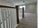 Spacious bonus room with neutral carpet, ceiling fan, and railing at 7420 Prato Ct, Wendell, NC 27591