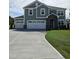 Two-story home with a stone-accented entrance, a three-car garage, and a well-manicured lawn at 7420 Prato Ct, Wendell, NC 27591