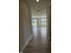 Hallway view with modern flooring leading to a bright, open living space with a sliding glass door at 7420 Prato Ct, Wendell, NC 27591