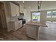 Contemporary kitchen featuring white cabinets, quartz countertops, a kitchen island, and stainless steel appliances at 7420 Prato Ct, Wendell, NC 27591