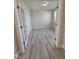 Empty office with light hardwood floors, a window, and a glass-paneled French door entrance at 7420 Prato Ct, Wendell, NC 27591