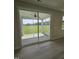 Screened patio view with a fan and sliding glass door looking out to a large grassy field at 7420 Prato Ct, Wendell, NC 27591
