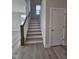 Staircase with neutral colored hardwood steps and white risers leading to the upper level of the home at 7420 Prato Ct, Wendell, NC 27591