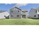 Home features a large backyard with green grass and a gray exterior at 1301 Jasmine View Way, Knightdale, NC 27545