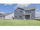 The home features a gray siding, lawn and a screened-in back porch at 1301 Jasmine View Way, Knightdale, NC 27545