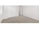 Neutral bedroom features plush carpet and a closet with double doors at 1301 Jasmine View Way, Knightdale, NC 27545