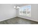 Sunny dining area featuring a modern chandelier and large windows for natural light at 1301 Jasmine View Way, Knightdale, NC 27545