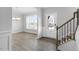 Welcoming entryway with wood-look flooring, staircase, and adjacent formal dining area at 1301 Jasmine View Way, Knightdale, NC 27545