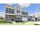 Inviting home with gray siding, a cozy front porch, and an attached two-car garage at 1301 Jasmine View Way, Knightdale, NC 27545