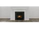 Elegant fireplace featuring a black surround and a white mantel with wood-look flooring at 1301 Jasmine View Way, Knightdale, NC 27545