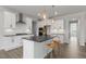 Modern kitchen with white cabinets, stainless steel appliances, and a large center island at 1301 Jasmine View Way, Knightdale, NC 27545