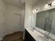 Bright, dual vanity bathroom with wood-look flooring and a large mirror offers space and functionality at 29 Longdale Dr, Graham, NC 27253