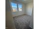 Bright, carpeted bedroom features two windows providing view of the neighborhood and ample sunlight at 29 Longdale Dr, Graham, NC 27253