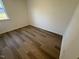 Cozy bedroom with neutral paint and wood flooring at 29 Longdale Dr, Graham, NC 27253