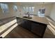 Open concept kitchen featuring a center island, gray cabinetry, stainless steel appliances, and wood flooring at 29 Longdale Dr, Graham, NC 27253