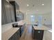Contemporary kitchen showcasing gray cabinetry, light countertops, and stainless steel appliances at 29 Longdale Dr, Graham, NC 27253