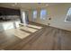 Bright living area with wood flooring, large windows, open to the kitchen area at 29 Longdale Dr, Graham, NC 27253