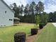 View of a two-story home with a large backyard, a screen porch and manicured landscaping at 135 Green Haven Blvd # 1, Youngsville, NC 27596