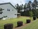 Side view of a two-story home with a backyard, screen porch and manicured landscaping at 135 Green Haven Blvd # 1, Youngsville, NC 27596
