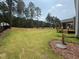 Wide backyard with a screen porch, trees and manicured landscaping at 135 Green Haven Blvd # 1, Youngsville, NC 27596