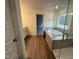 Bathroom featuring a glass-enclosed shower, soaking tub, and stylish wood-look flooring at 135 Green Haven Blvd # 1, Youngsville, NC 27596