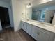 Bathroom with dual sink vanity, quartz countertop, and separate tub and tiled shower at 135 Green Haven Blvd # 1, Youngsville, NC 27596