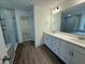 Bathroom with a large vanity with dual sinks, a walk-in shower, and wood-look floors at 135 Green Haven Blvd # 1, Youngsville, NC 27596