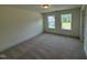 Inviting bedroom featuring plush carpeting and two windows providing ample natural light at 135 Green Haven Blvd # 1, Youngsville, NC 27596