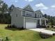 View of a two-story home with a two-car garage, covered porch and a concrete driveway at 135 Green Haven Blvd # 1, Youngsville, NC 27596