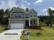 Charming two-story home with a well-manicured lawn, covered porch and a two-car garage at 135 Green Haven Blvd # 1, Youngsville, NC 27596