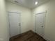 Interior hallway featuring hard wood flooring and two white doors at 135 Green Haven Blvd # 1, Youngsville, NC 27596