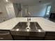 Kitchen island with sink, stainless steel appliances, with view of stairs and living room at 135 Green Haven Blvd # 1, Youngsville, NC 27596