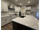 Bright kitchen features white cabinets, stone countertops, an island, and stainless steel appliances at 135 Green Haven Blvd # 1, Youngsville, NC 27596