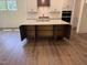 Spacious kitchen island with bar stool seating, ample cabinet space, and stainless steel appliances at 135 Green Haven Blvd # 1, Youngsville, NC 27596
