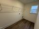 The laundry room has new wood-look floors, hookups, a metal rack, and a window for light at 135 Green Haven Blvd # 1, Youngsville, NC 27596