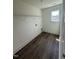 Functional laundry room with wood-look flooring, a window, and space for a washer and dryer at 135 Green Haven Blvd # 1, Youngsville, NC 27596