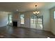 Open-concept living room with fireplace, wood floors, and sliding door access to outdoor patio at 135 Green Haven Blvd # 1, Youngsville, NC 27596