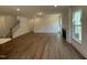 Spacious living room featuring a fireplace, wood floors, and an abundance of natural light at 135 Green Haven Blvd # 1, Youngsville, NC 27596