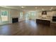 Open-concept living room featuring wood floors, a fireplace, and an adjoining gourmet kitchen at 135 Green Haven Blvd # 1, Youngsville, NC 27596